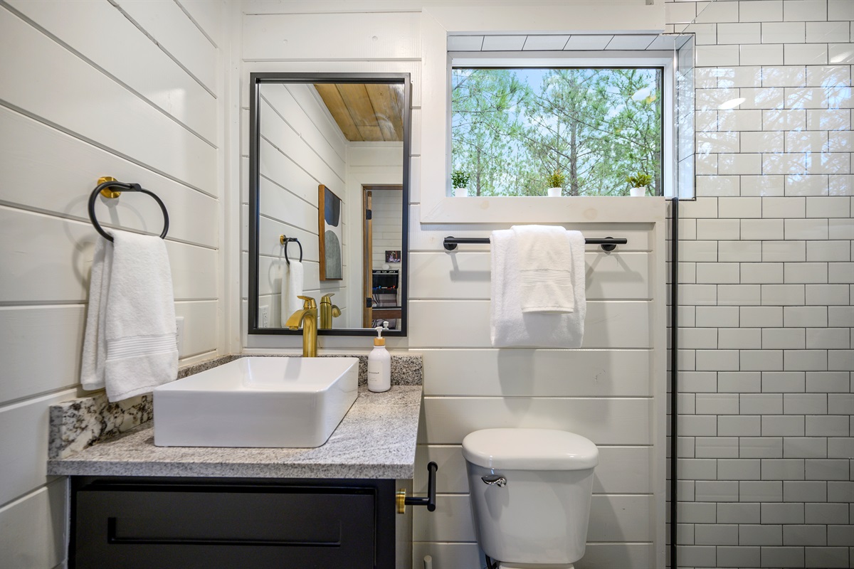 A clean and functional bathroom featuring a sink and toilet, designed for everyday comfort and convenience during your stay. ✨