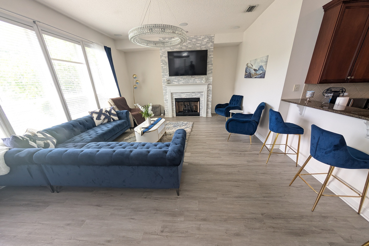 Gather together in the main living room, featuring comfortable seating and a cozy fireplace centerpiece.