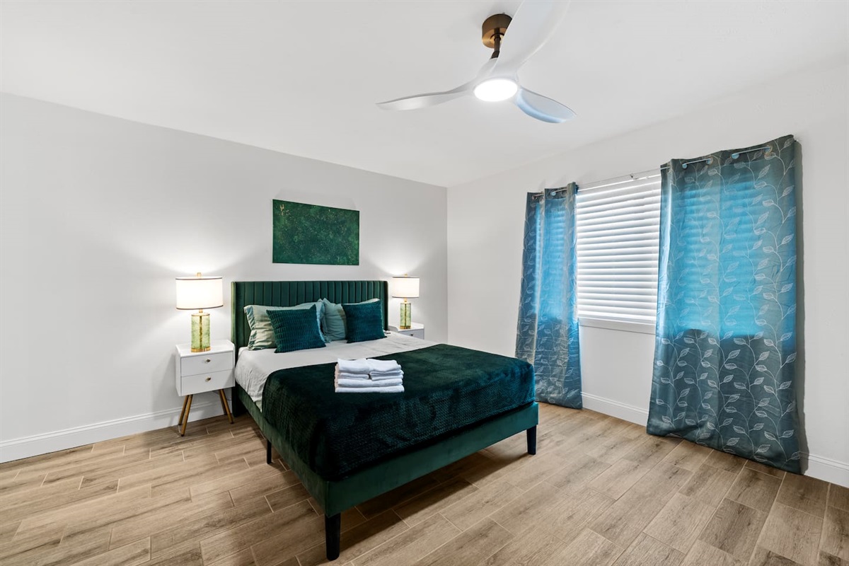 Relax in the stylish primary bedroom with vaulted ceilings and natural light.