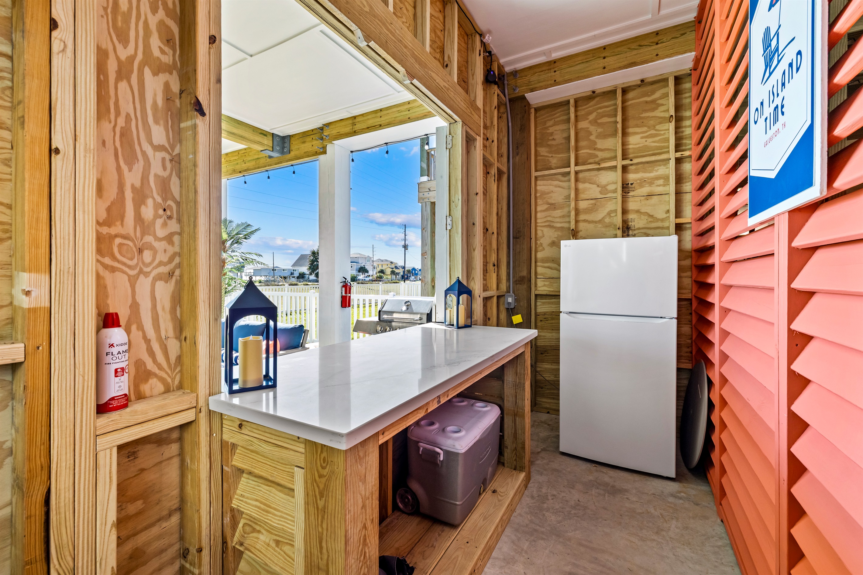 Summer kitchen complete with outdoor fridge, cooler and plenty of space to serve refreshments at the bar!