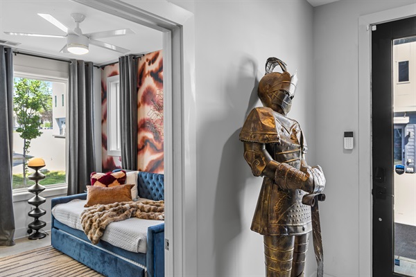 Charming Entrance and Bedroom: Relax on a plush full day bed with full trundle underneath surrounded by vibrant art and unique decor elements!