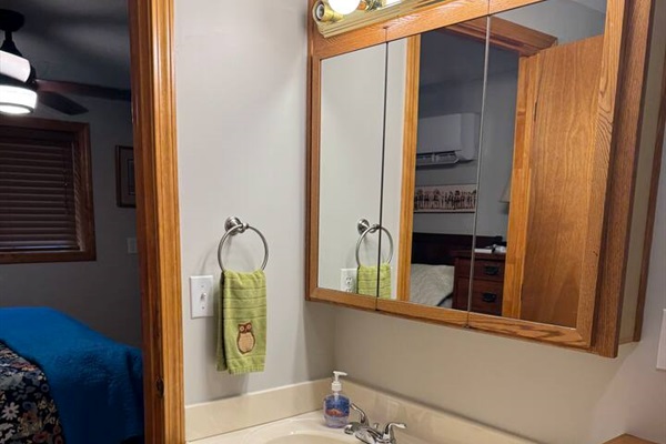 Bathroom has toilet, sink with lots of lighting, shower, and washer and dryer. Outdoor shower available in summer.