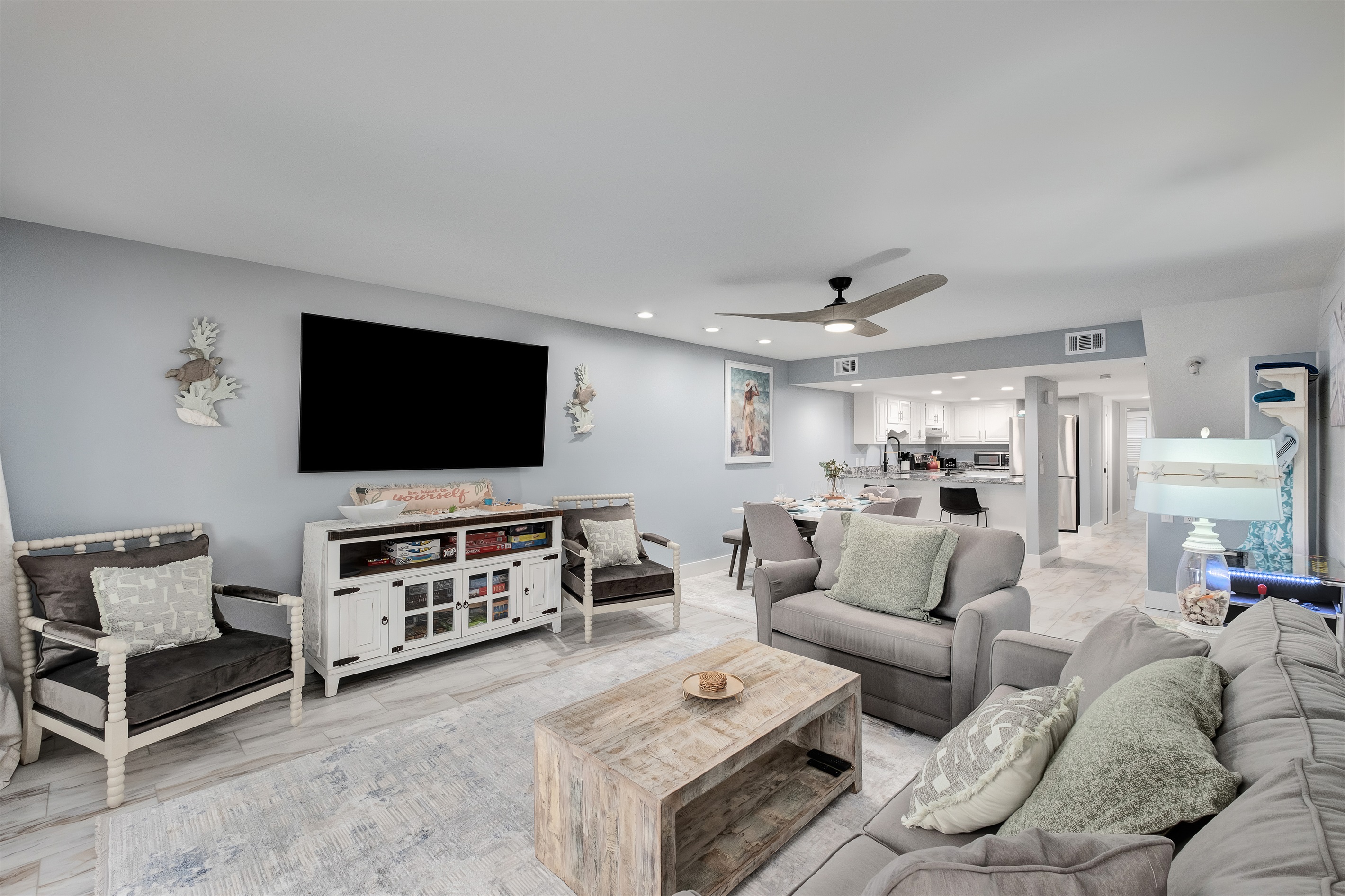 Relax in the spacious living room featuring modern amenities and a large flat-screen TV. Ideal for family entertainment.