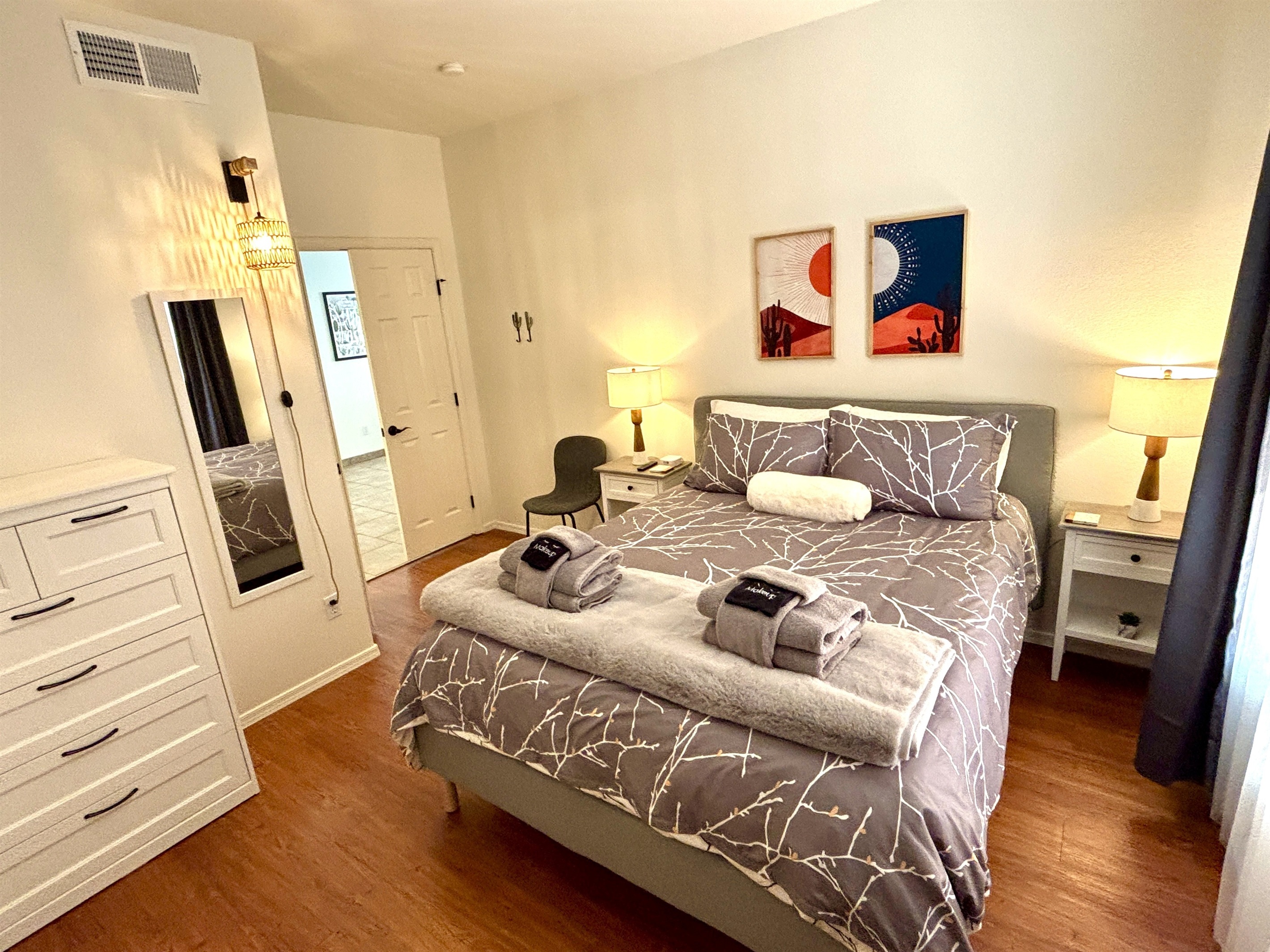 Queen bedroom downstairs with 55" smart Tv and blackout curtains