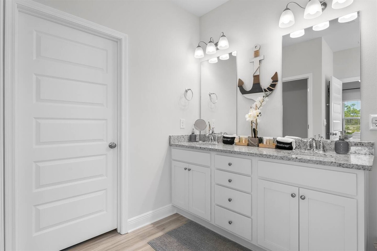 Relax and recharge in this snug and stylish bathroom with lots of drawers and cabinets.