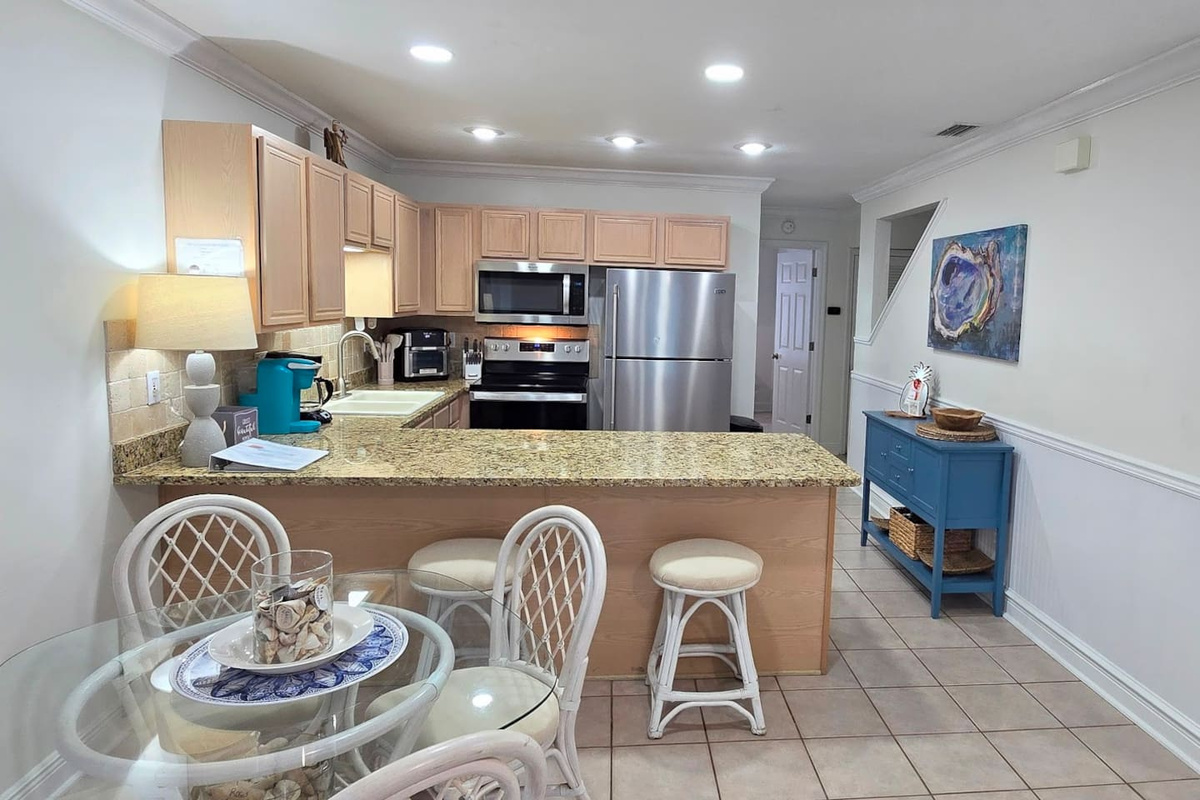 Pull up to the breakfast bar with your coffee while someone else cooks &mdash; the dining area keeps the group together from first meal to last.