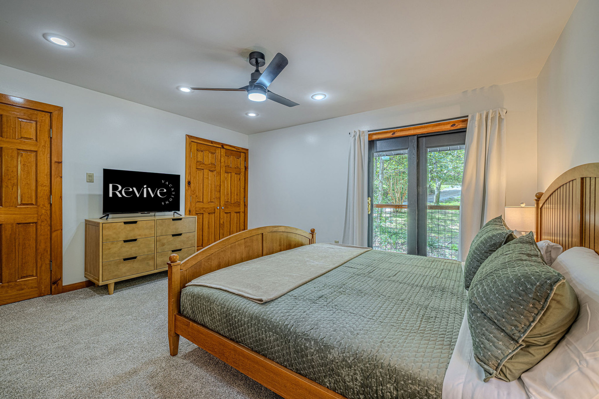This inviting upstairs king retreat offers private deck access, generous closet space, and a connecting bathroom that conveniently serves the upper level.