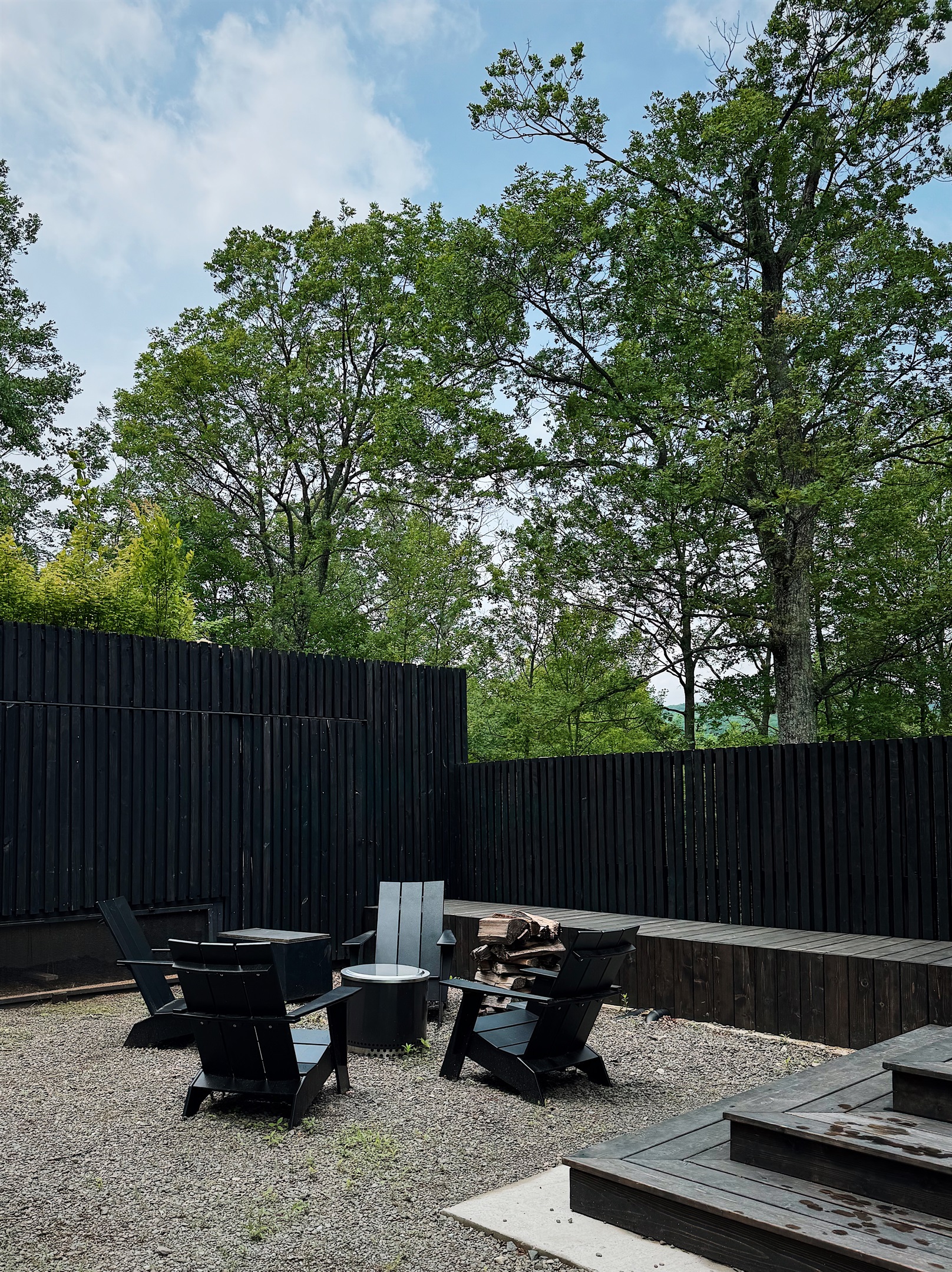 Fire pit in the dooryard with firewood and starters.