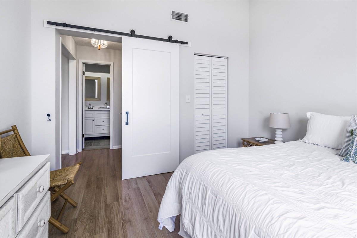 Relax in the serene comfort of the main bedroom, featuring plush bedding, peaceful views, and a private en-suite bathroom for added convenience and privacy.