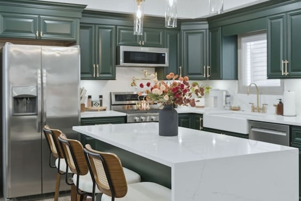 Another view of the spacious kitchen featuring the large island with bar seating—perfect for morning coffee or casual meals.