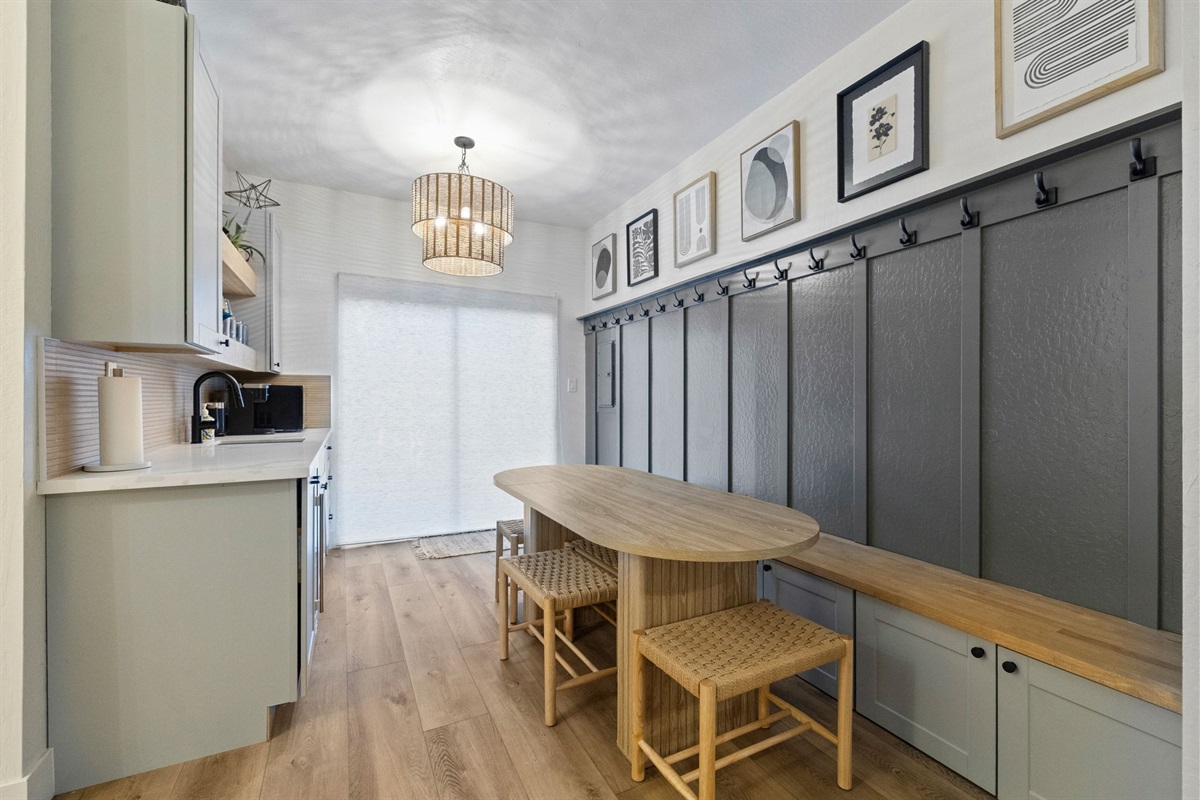 Kitchenette with dining, games, wall hooks and a slider to access the front of the house.