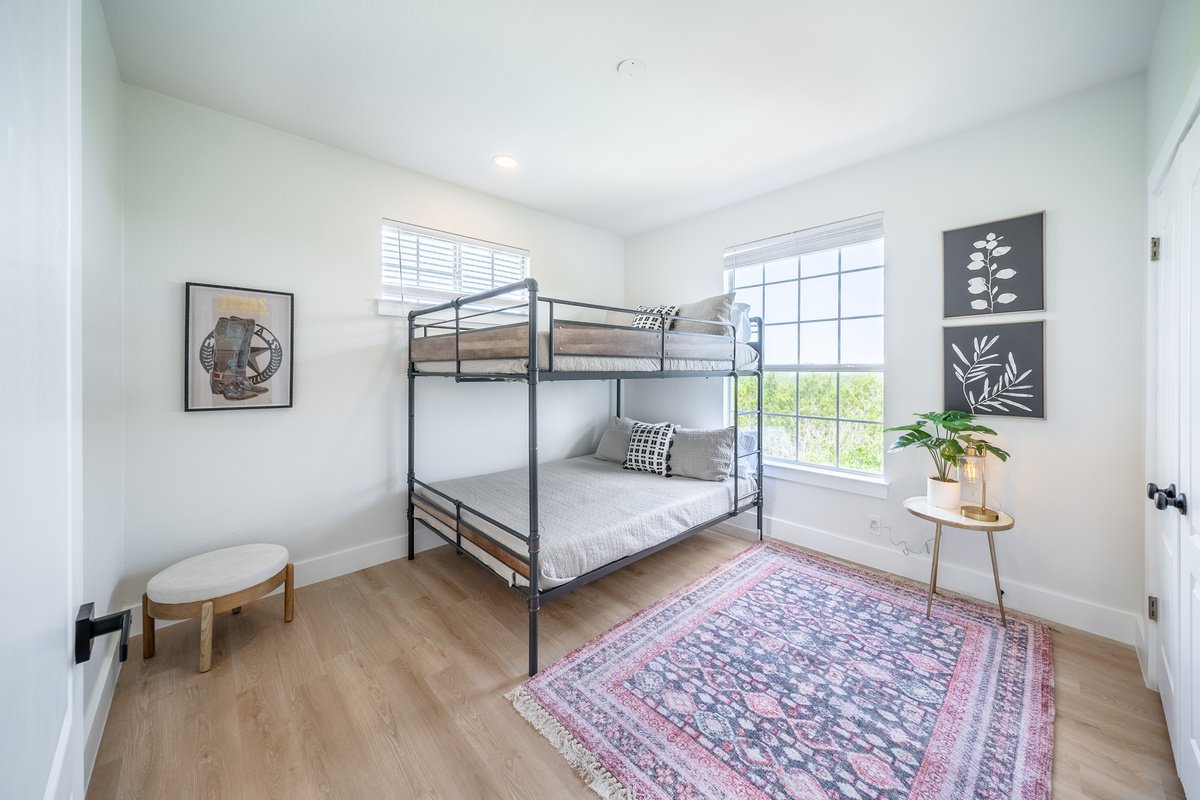 Another comfortable bunk room, filled with natural light and cozy textures.