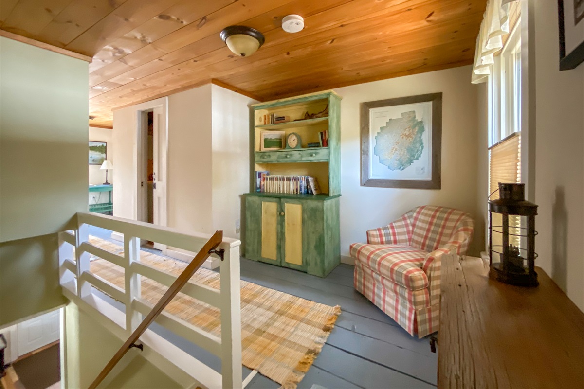 Farmhouse is a combo of modern and antique, about as eclectic as we can make it. This is the top of the stairs, where I sit and read by the window overlooking the lake.