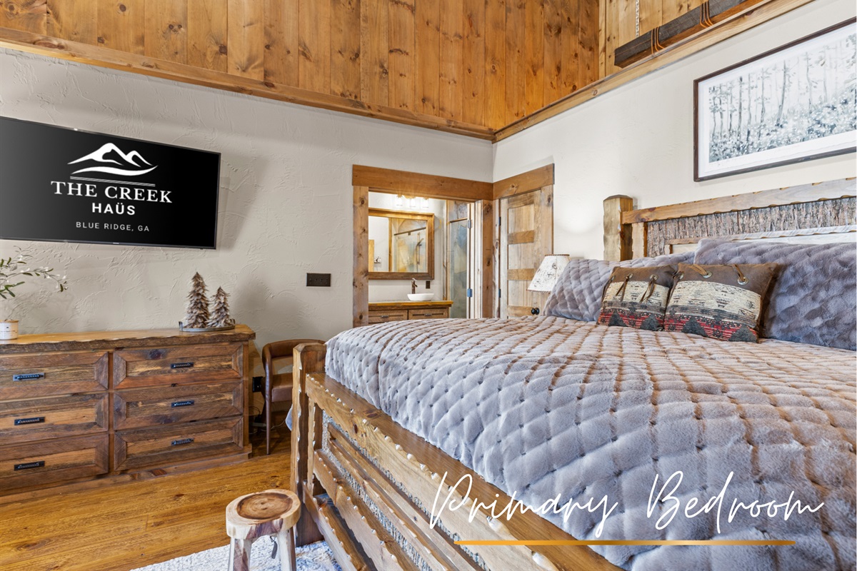 Bedroom1: Unwind in the comforts of the master suite, featuring a luxurious king-sized bed, rustic charm, and warm wood accents for a cozy, inviting retreat.