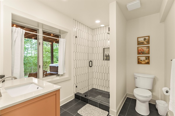 Lower level full bathroom with glass, walk-in shower. 