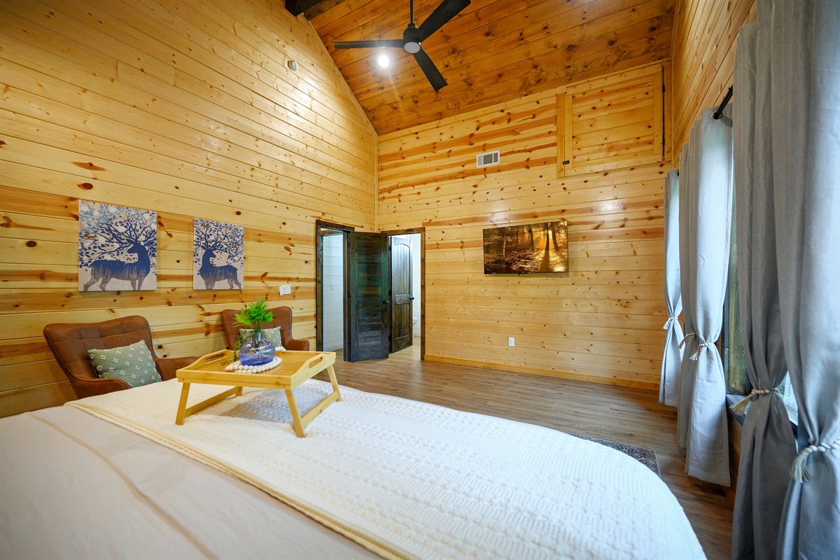 Spacious primary suite. Vaulted ceinings, forest views and reading chairs.