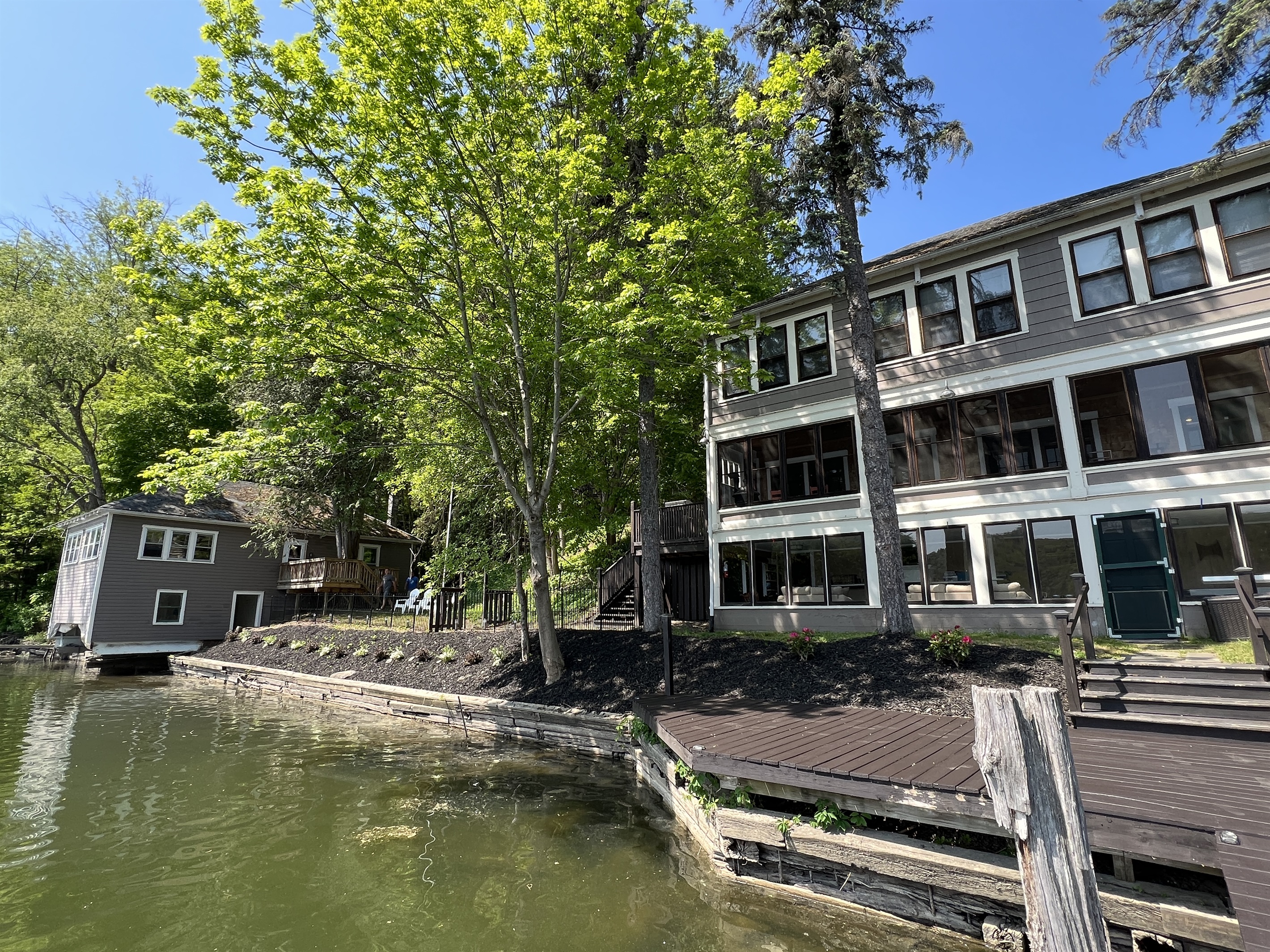 The Adirondack Waterfront Compound main house on the right boathouse on the left.