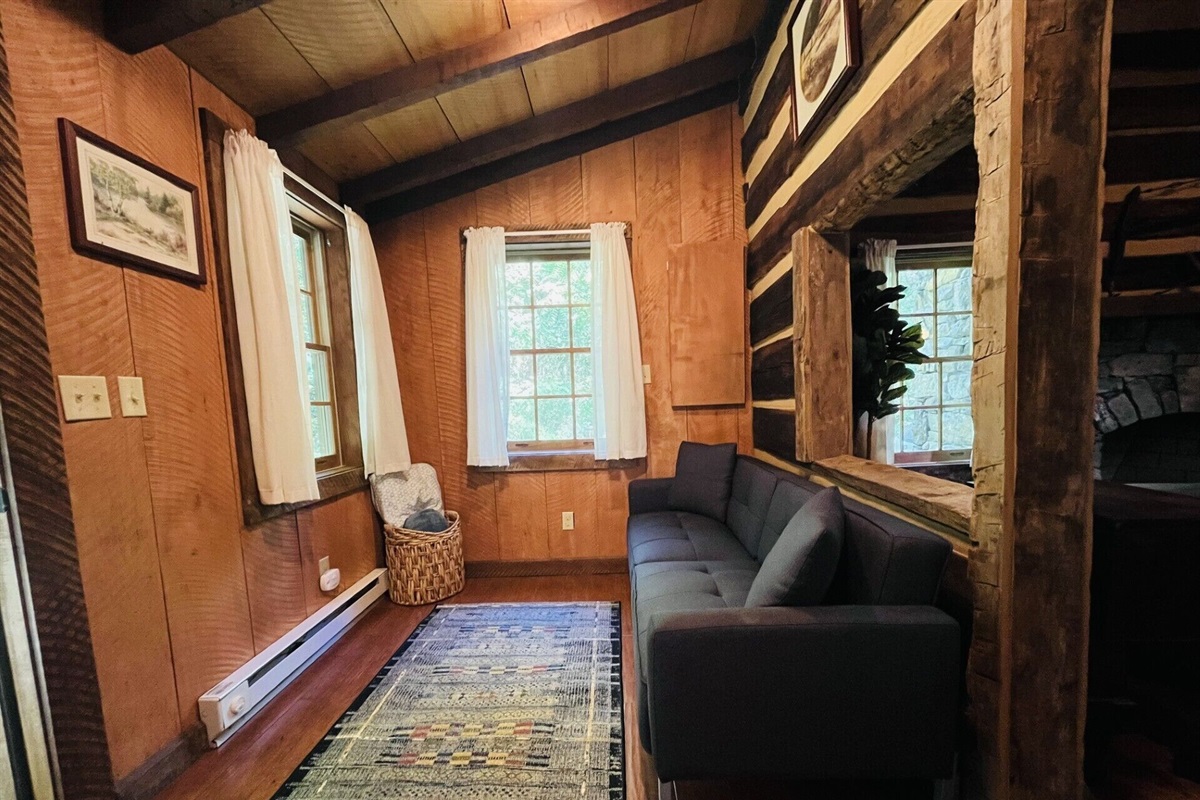 Linens for the sleeping couch are in the basket in the corner.