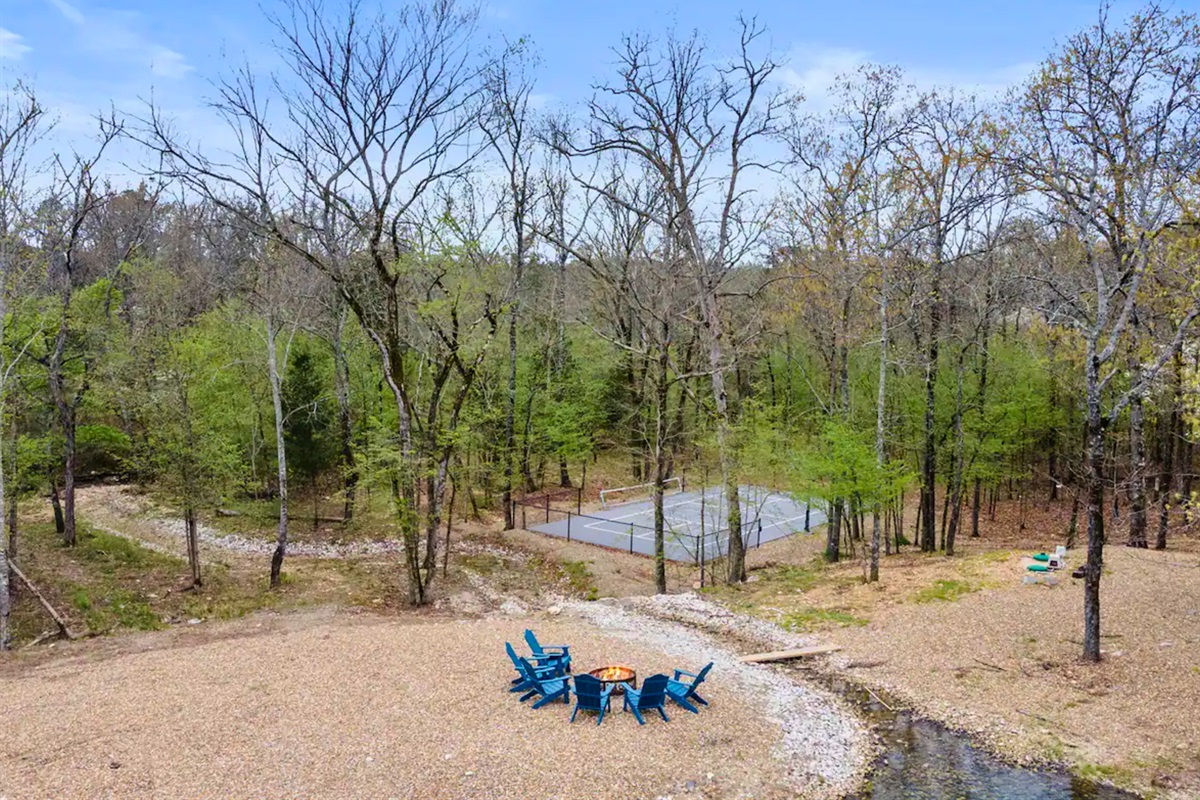 Elevate your outdoor gatherings with this inviting fire pit area, complete with comfy seating. It's the ultimate spot for storytelling and stargazing on clear nights.