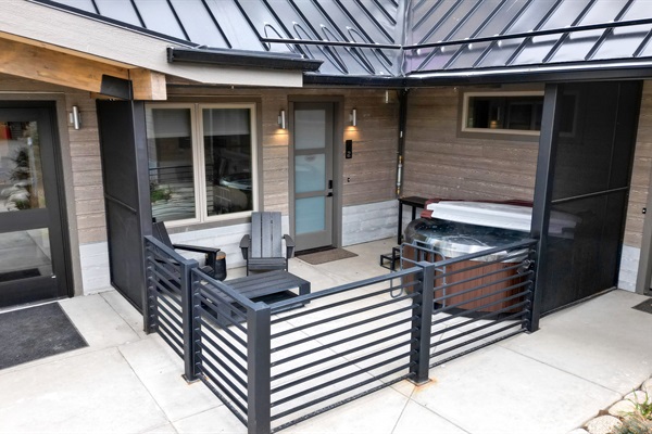 Private patio, hot tub, and property entrance