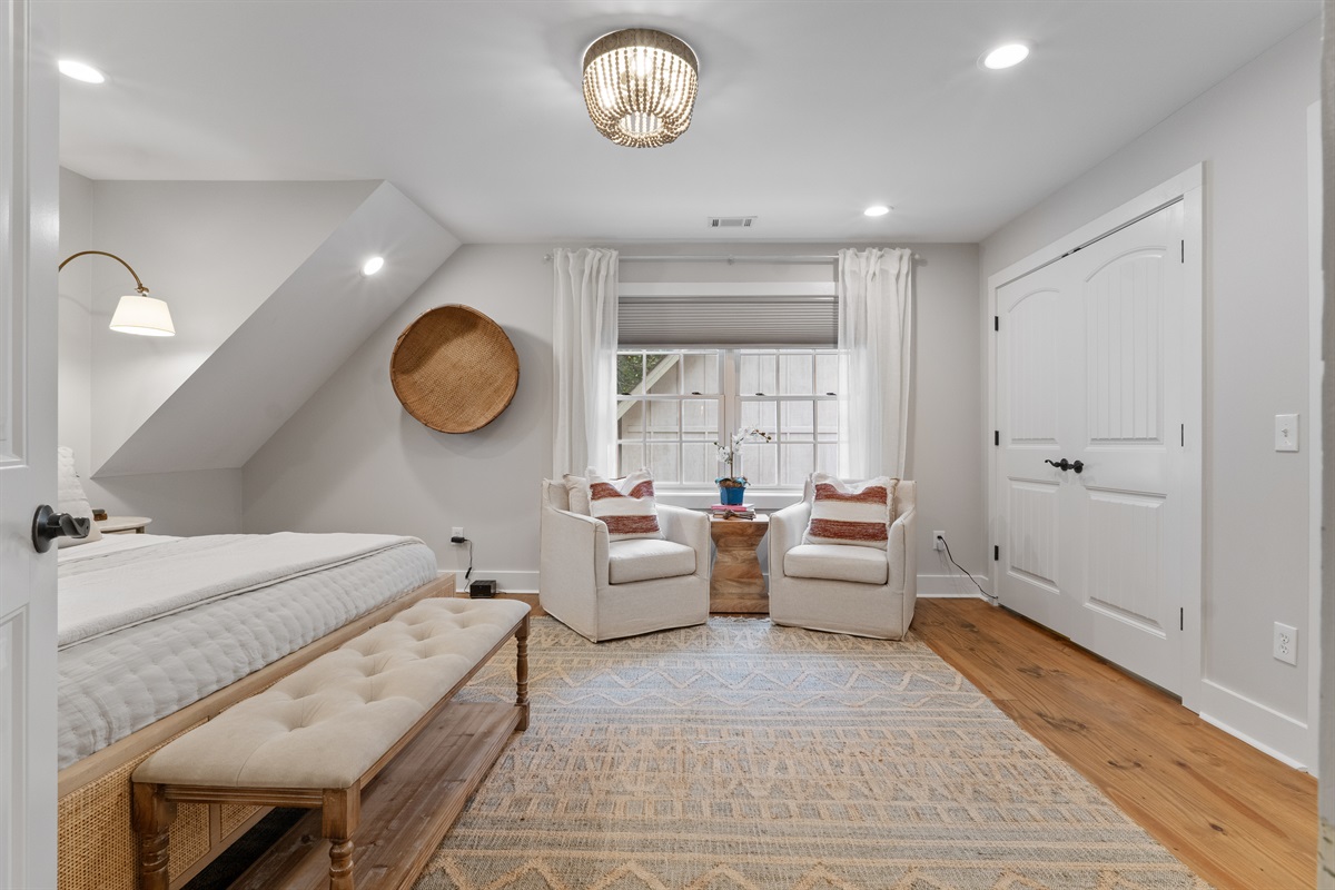 The second bedroom includes a cozy seating area, perfect for relaxing, reading, or enjoying a quiet moment.
