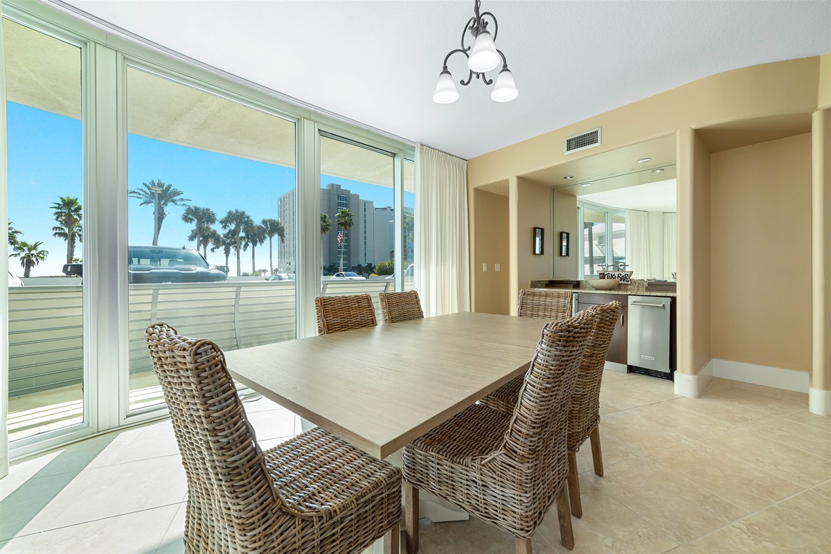 Gather around the elegant dining table, ready for memorable meals and conversations in this beautifully appointed bayfront condo.