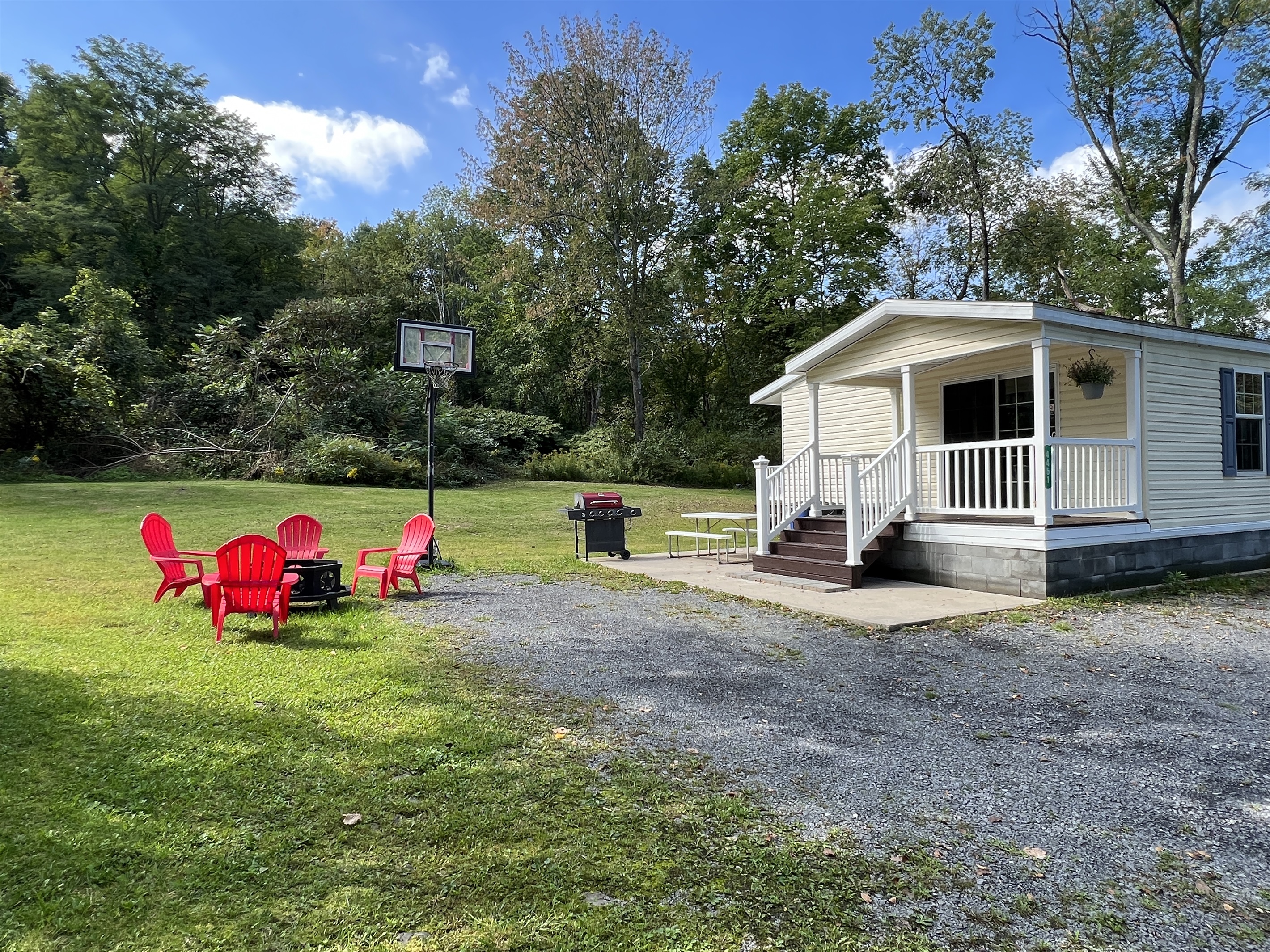 At Home Base Basketball hoop, fire pit and outside area.