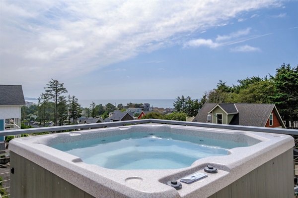 Relax in the private hot tub overlooking sweeping ocean views for a truly elevated coastal experience.