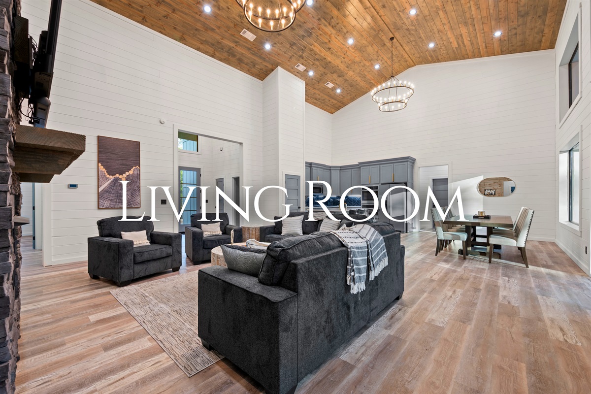 The bright and open living room features soaring ceilings, comfortable seating, and a welcoming layout that makes it easy for everyone to gather together.