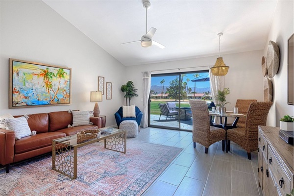 Villa living room with patio access and golf course view