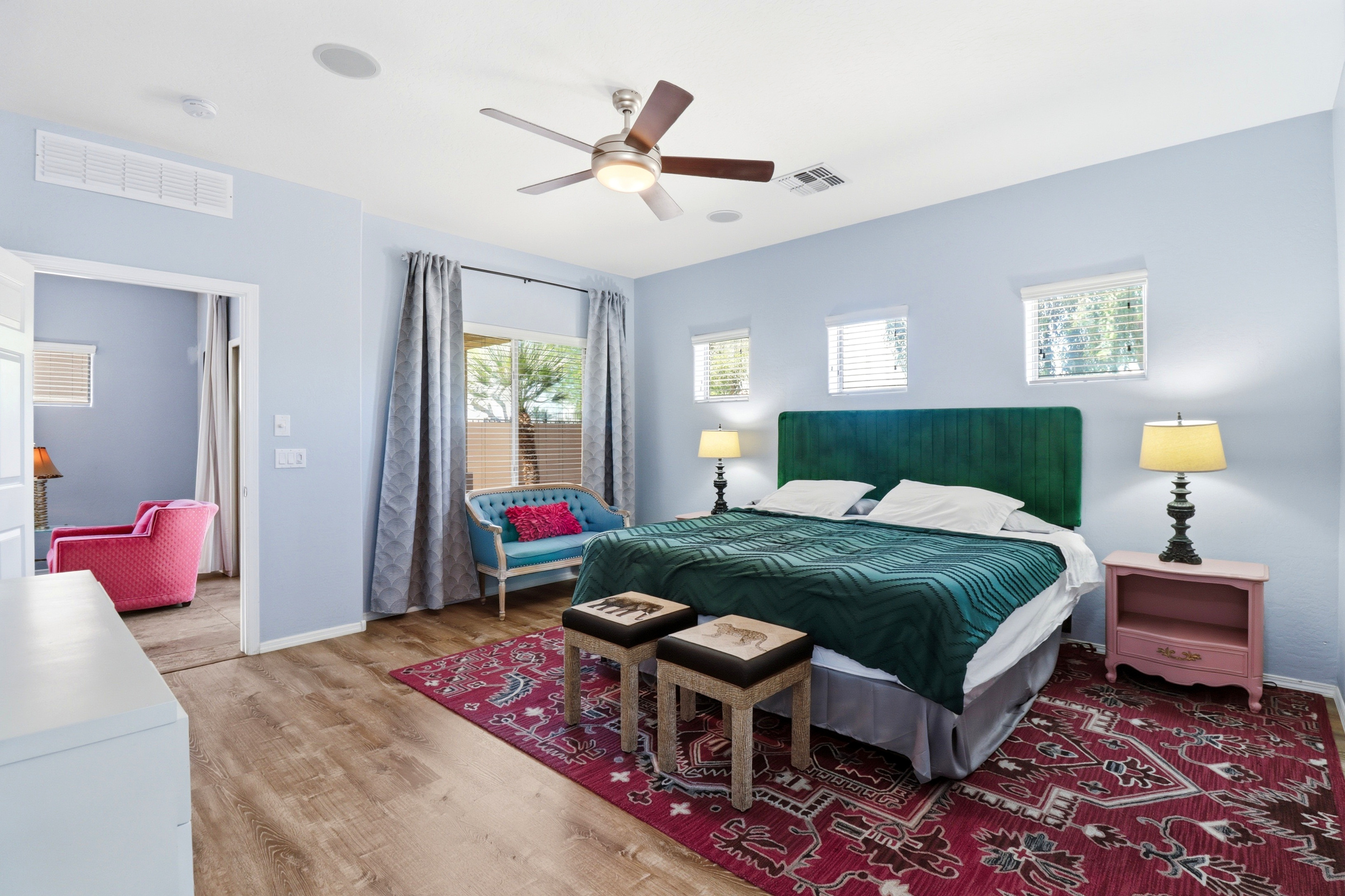 Spacious master bedroom with a king bed, and comfy seating. 