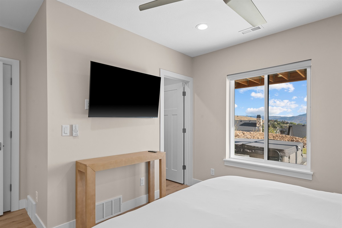Bedroom with streaming TV, mountain views, and cozy finishes