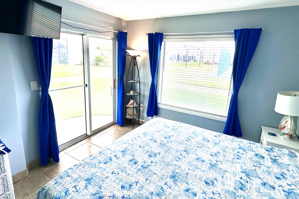 Master Bedroom with king bed, on-suite bath, sliding door, and black-out curtains.