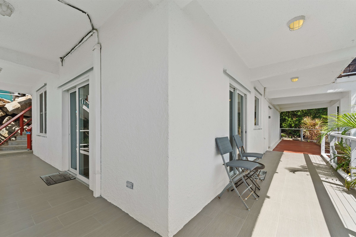 The stairs on the left come down from the pool deck and lead to the lower apartment.