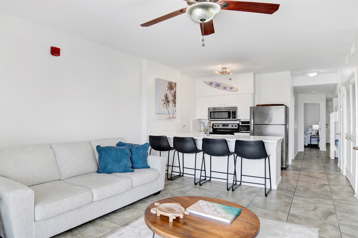 Living room with sleeper sofa, a 2nd sofa, smart TV, ceiling fan and balcony access