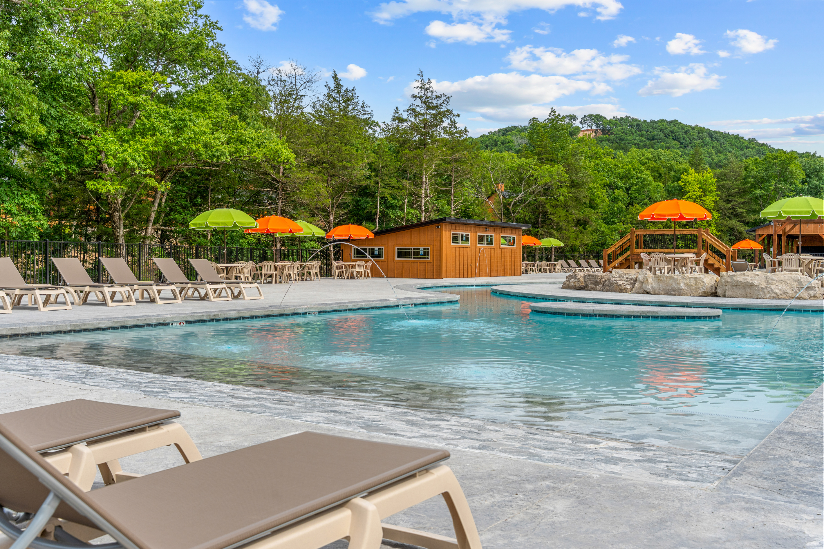 Autumn color surrounds the outdoor pool, proof that Tall Timbers shines in every season.