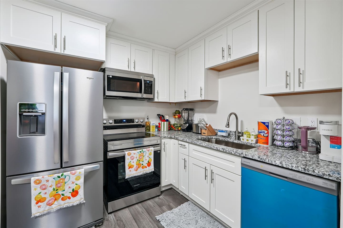 Full kitchen thoughtfully stocked with everything you may need including cookware, utensils, dishes, and essential appliances perfect for preparing meals and enjoying a true home-away-from-home experience.