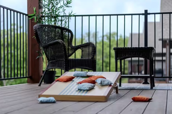 Private deck with cornhole game