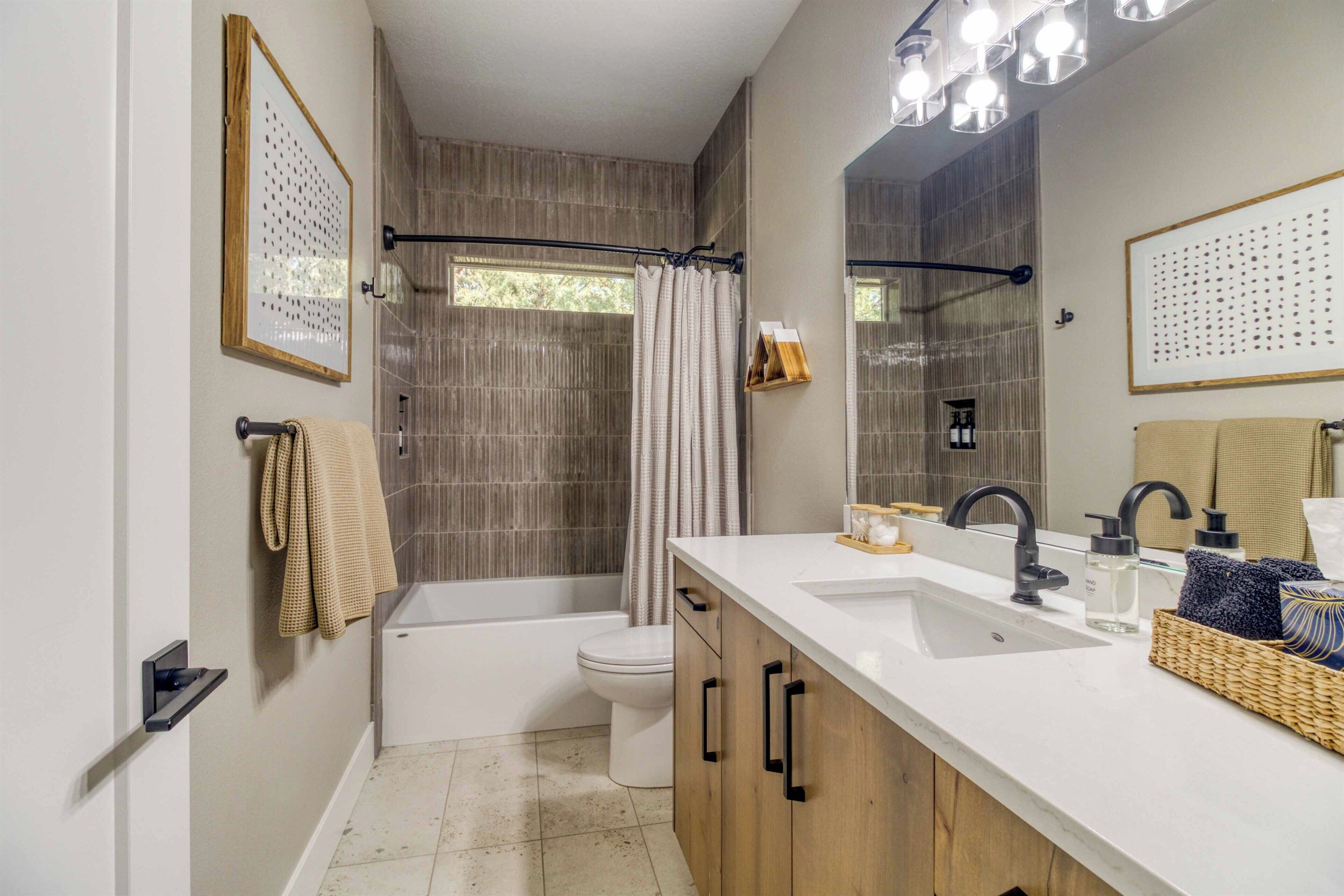 Downstairs bath #2 services King Bedroom #3 and the Bunk Room.  Tile tub/shower.