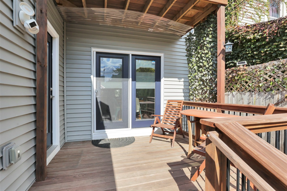The back deck, with seating for two and a small table