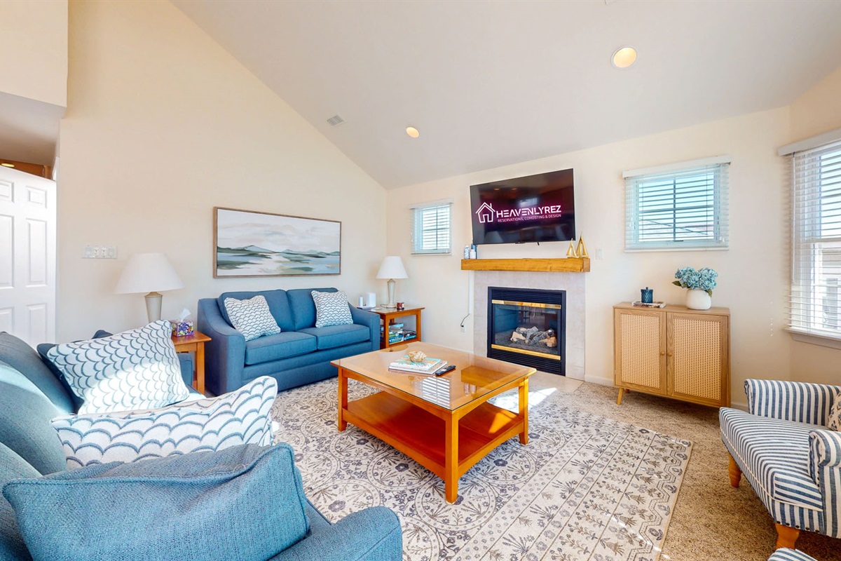 Spacious living room with flatscreen TV and fireplace 