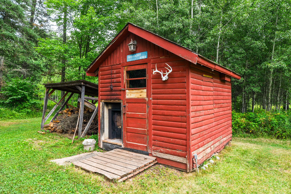 Wood burning sauna and wood pile