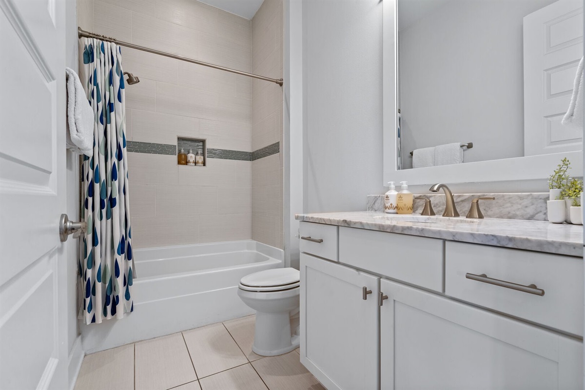 Guest bath with tub-shower combo.