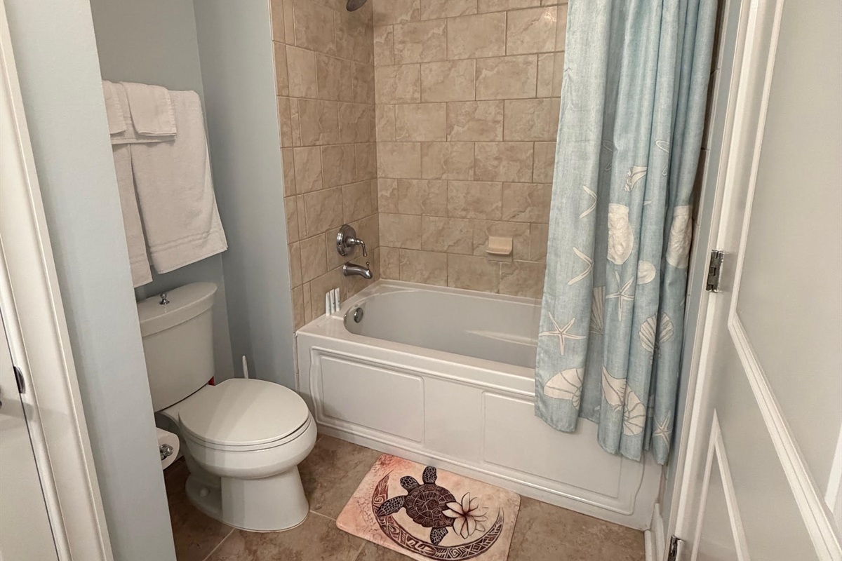 Third full bathroom with granite vanity and tub/shower combo—perfect for keeping everyone comfortable during busy beach mornings.