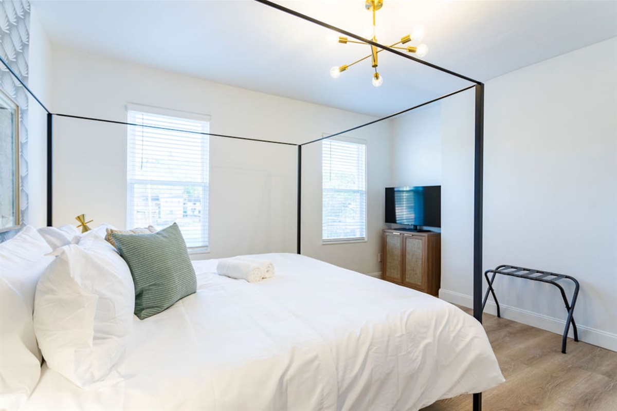 Luxurious king-sized bedroom featuring a unique, eye-catching bed frame for a stylish and comfortable stay.