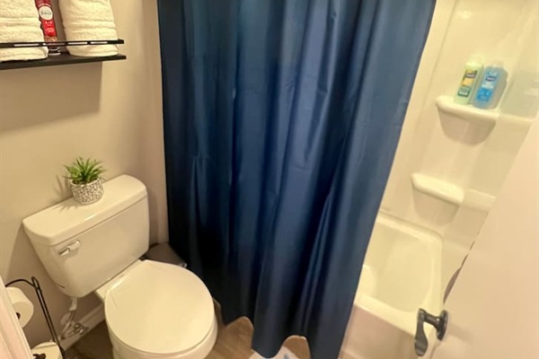 Bathroom with a shower, fresh towels, and simple essentials for daily use.
