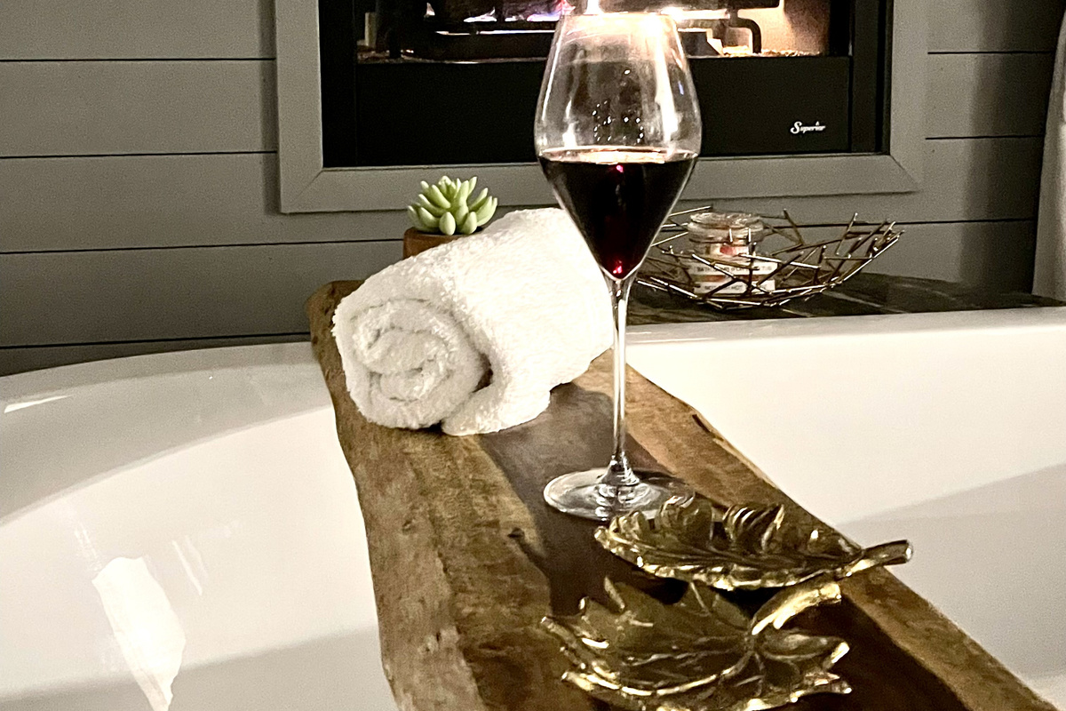 Enjoy the large soaking tub in front of the romantic see-through fireplace!  This beautiful hand finished black walnut live cut edge is perfect for your favorite beverages!