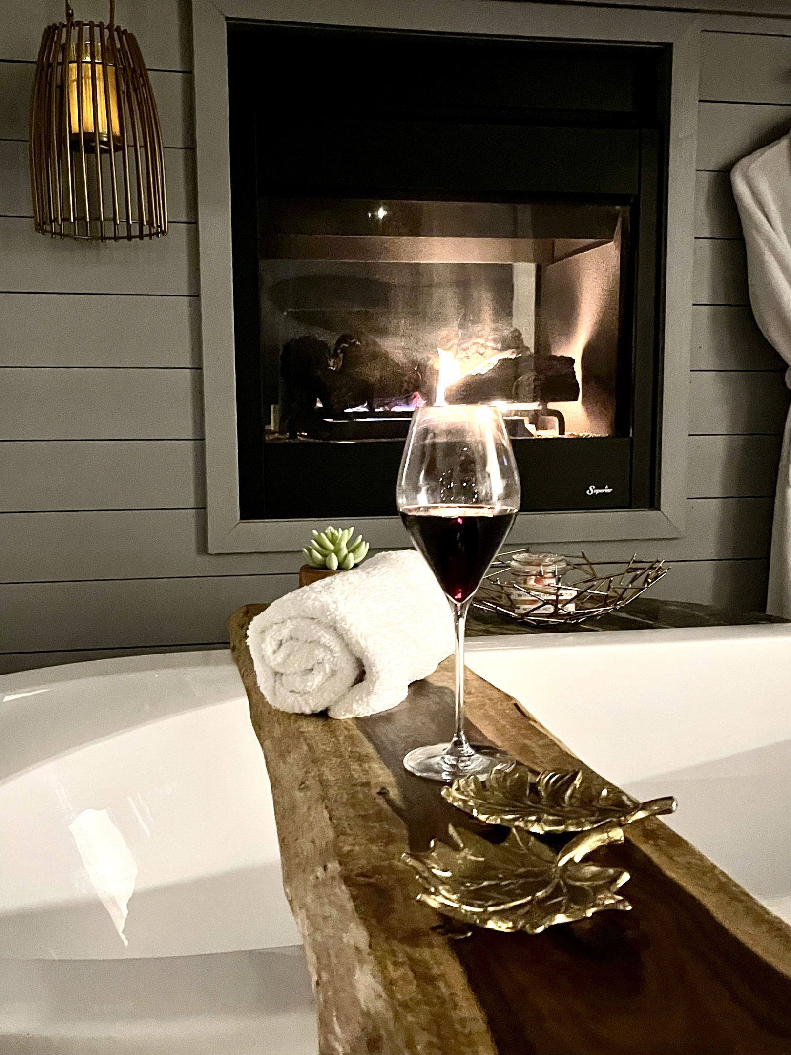 Enjoy the large soaking tub in front of the romantic see-through fireplace!  This beautiful hand finished black walnut live cut edge is perfect for your favorite beverages!