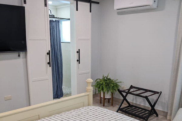 This is the view of the 2nd bedroom on the 1st level. Since this picture was taken we added a makeup table/desk where the luggage rack is. This queen bed is VERY comfortable! The bed is also adjustable(in case you want to raise it to read).