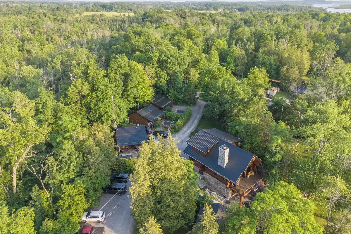 Aerial view of Bear Lodge surrounded by forest and waterfront scenery